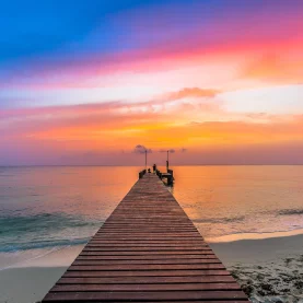 A peaceful sunset over a pier, reflecting moments of clarity and serenity facilitated by Thrive Therapy.